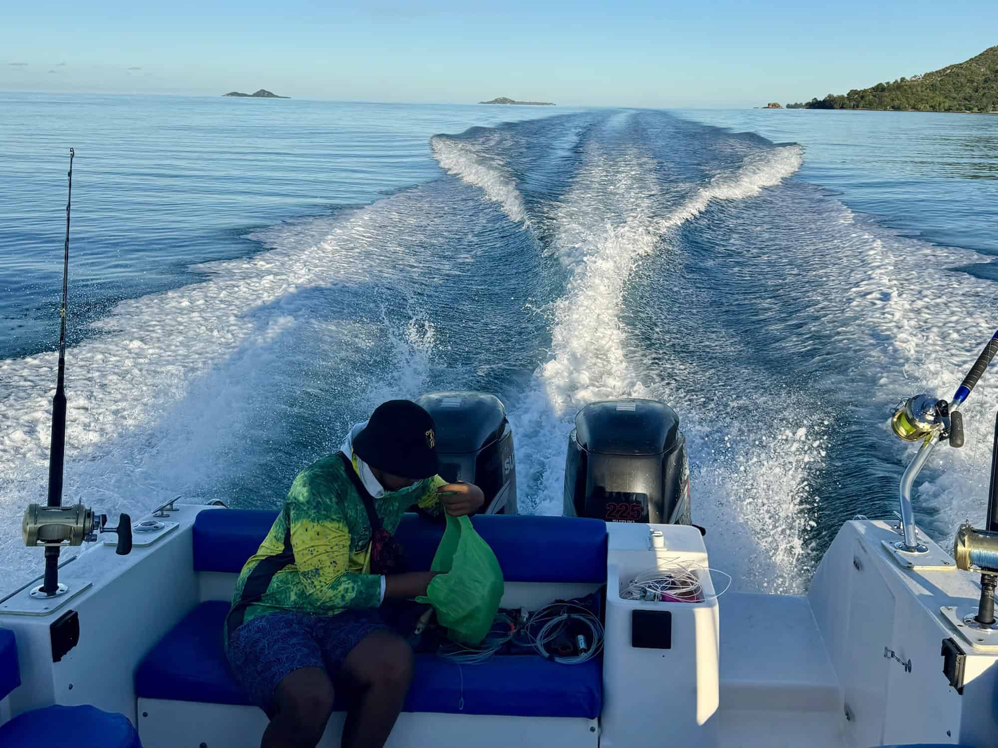 Boat at anchor near granite boulders