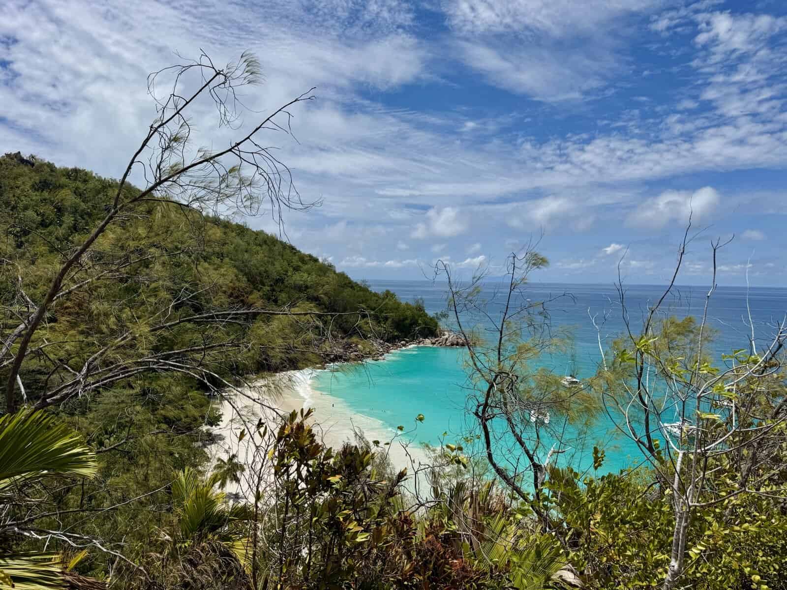 View over turquoise water from the Anse Lazio – Anse Georgette trail