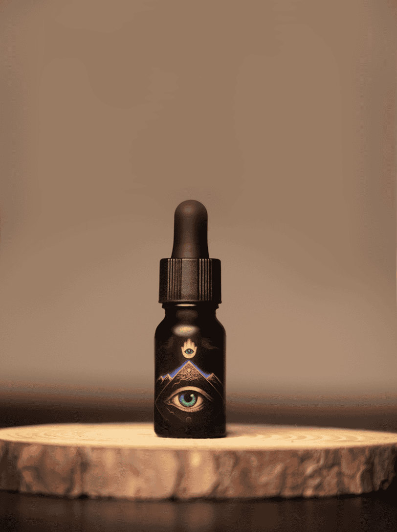 Liquid oracle oil dropper bottle with mystical eye and mountain artwork, used for spiritual healing, sacred practices, and energy work in shamanic rituals. Perfect for holistic wellness and intuitive guidance.