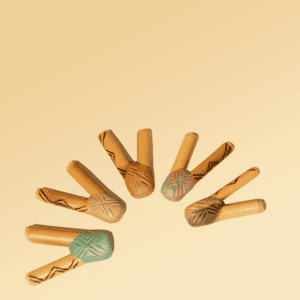 Colorful wooden rainsticks with tribal patterns, traditional musical instruments used in Shaman Hape rituals, arranged in a semi-circle on a beige background.