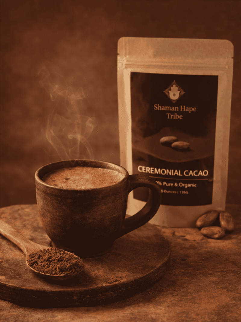Ceremonial grade cacao powder in a rustic cup with a steaming beverage, with a package of Shaman Hape Ceremonial Cacao in the background, emphasizing purity and organic quality.