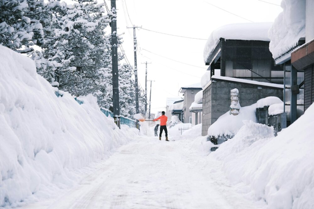 a person walking down a snow covered street
