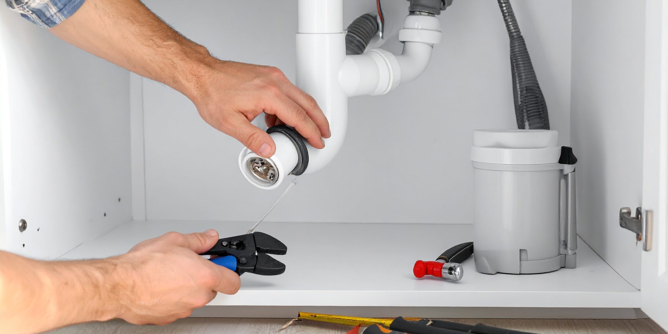 Plumber-Repairing-Kitchen-Sink-Drain-Under-Cabinet | Sheet Happens Plumbing & Drain