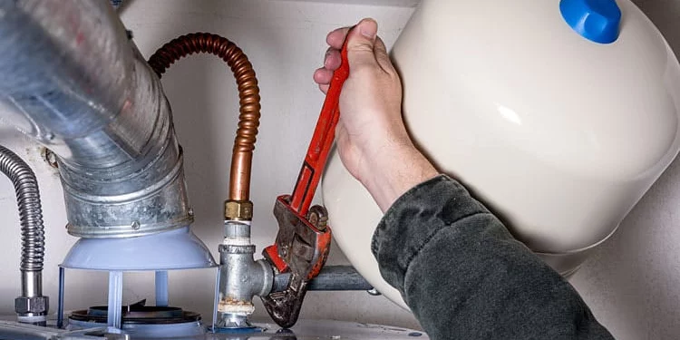Plumber Working on Water Heater | Sheet Happens Plumbing and Drain