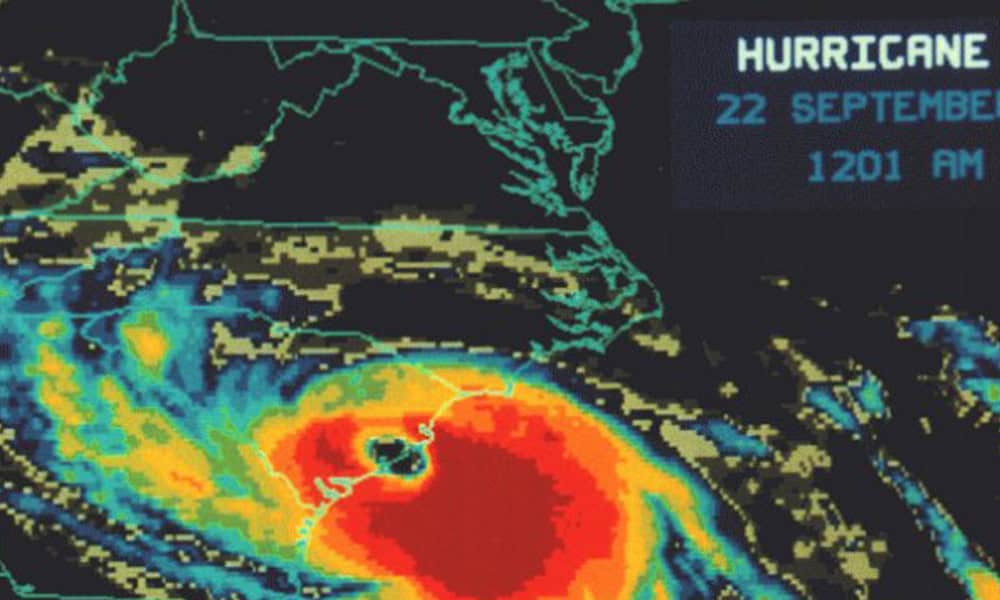A weather radar map showing a hurricane with bright red and orange areas indicating intense weather, dated 22 September at 12:01 am.