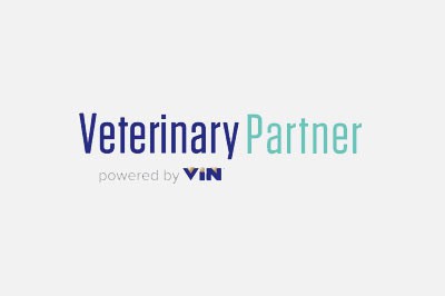 Logo of veterinary partner powered by VIN, featuring the text "veterinary partner" in bold blue letters and "powered by VIN" in light teal beneath it on a gray background.