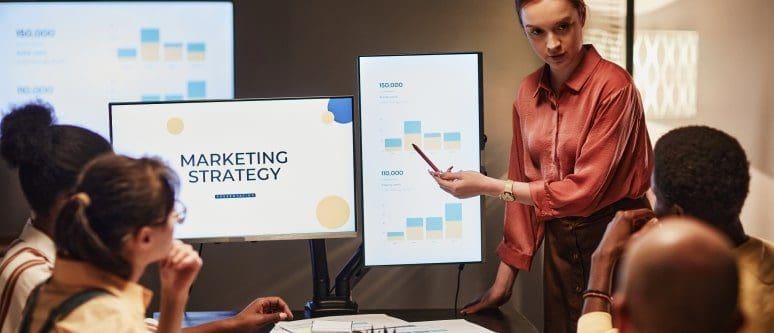Data-driven marketing strategy presentation in a business meeting with diverse team members.