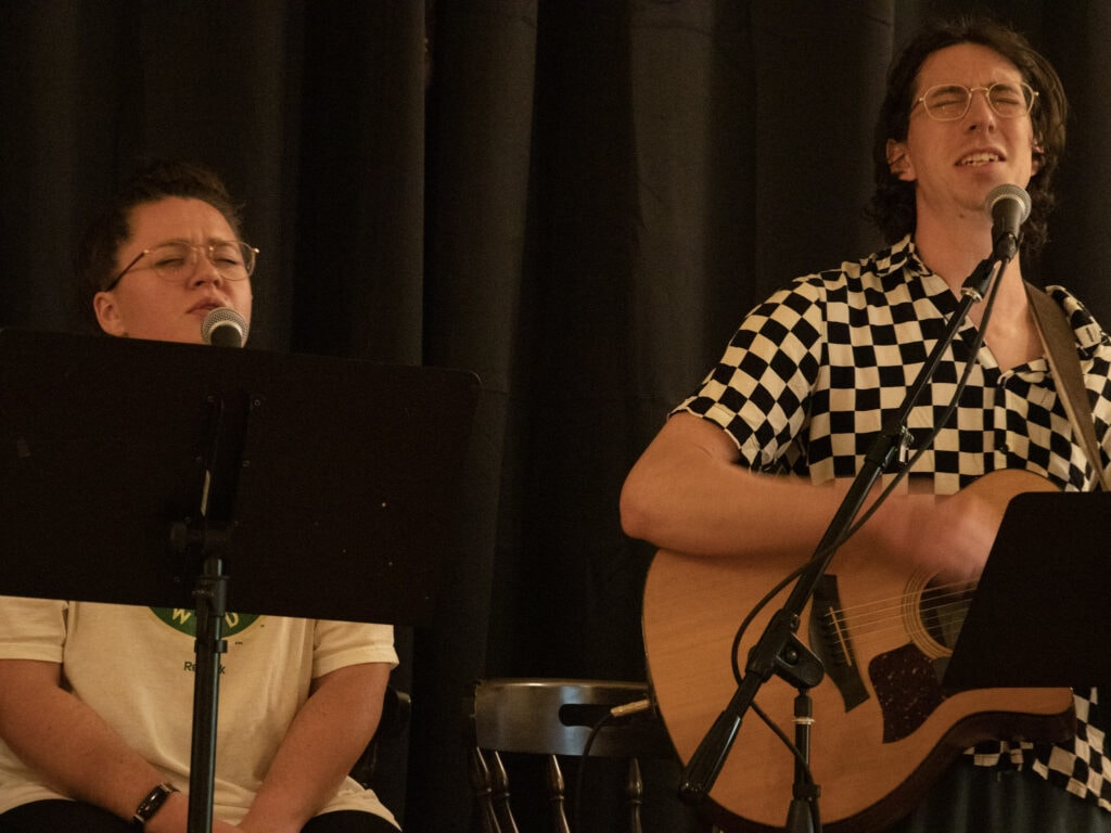Serene musical performance at Singing Feather Ministries, worship and praise through singing and guitar playing in a church setting.
