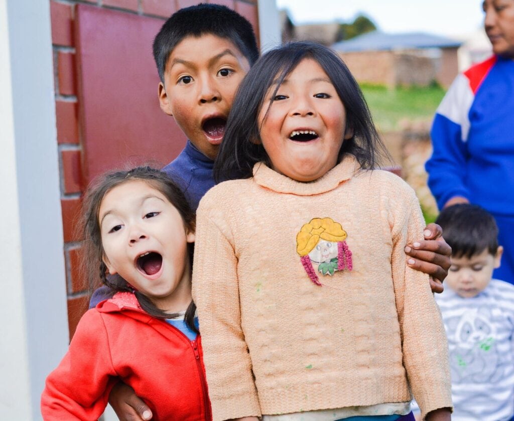 Joyful children outdoors at Singing Feather Ministries, spreading faith and happiness.