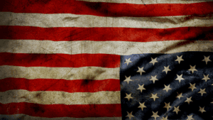 American flag with vintage, worn texture representing patriotism and faith.