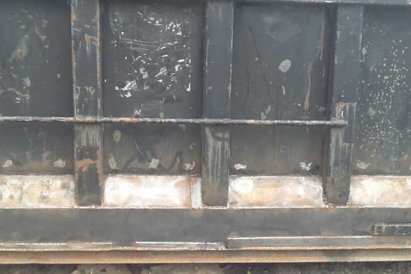 Container wall with visible wear and rust, part of SL Container Systems' durable shipping containers.