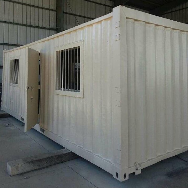 Portable container office with windows for construction site management.
