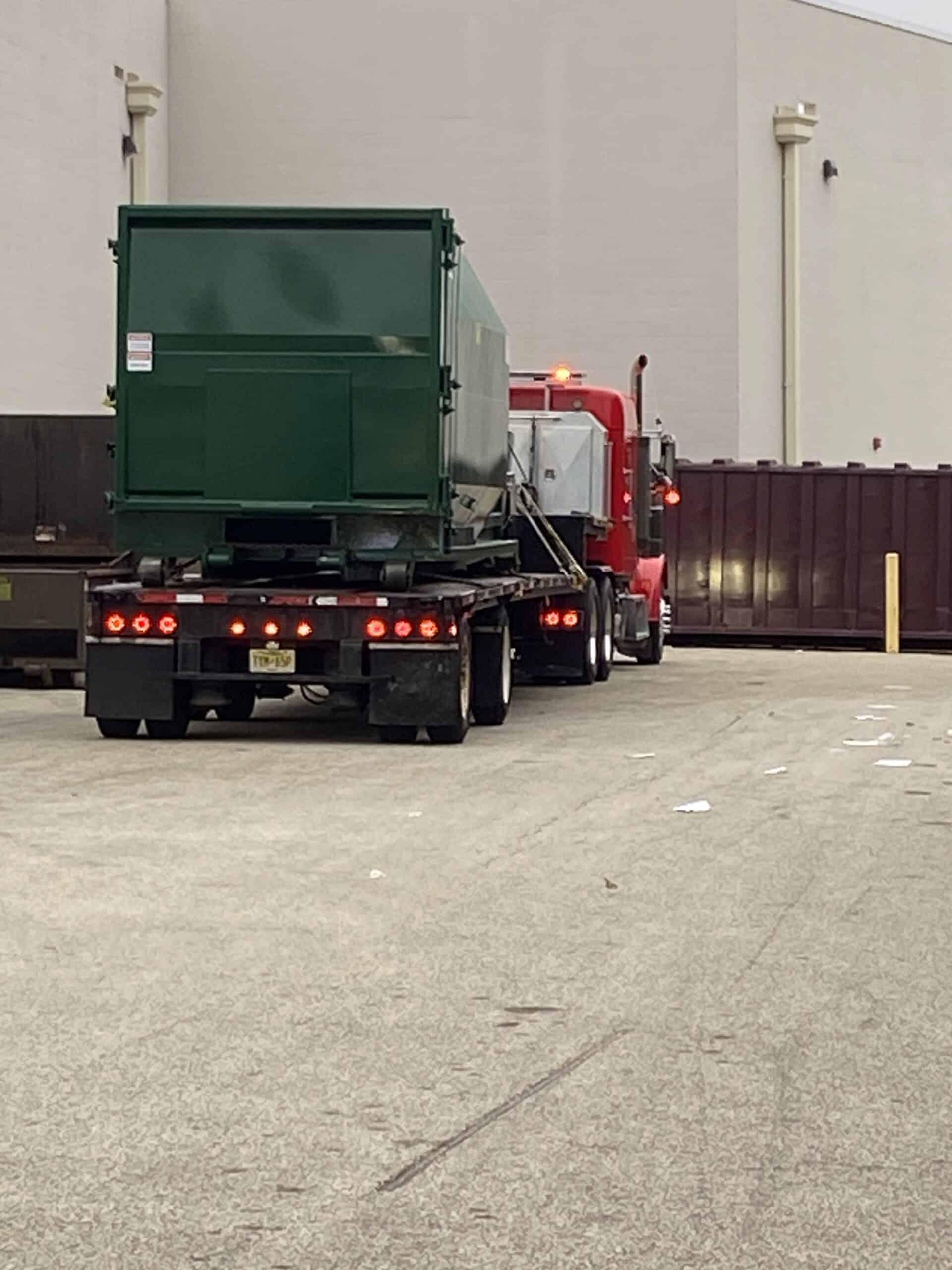 Container delivery truck at SL Container Systems facility.