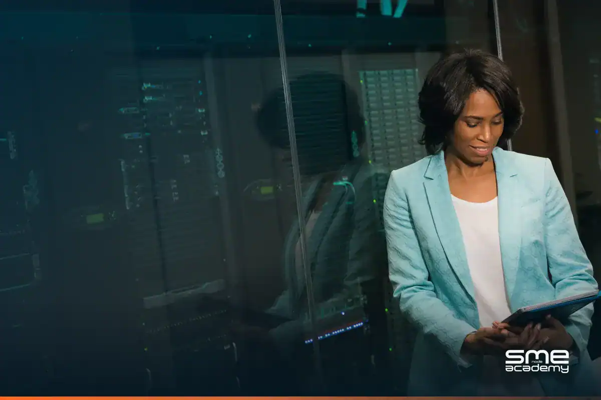Businesswoman using tablet in data center for CCIE exam preparation.