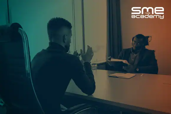 Network engineer in interview with a recruiter at SMEnode Academy office.
