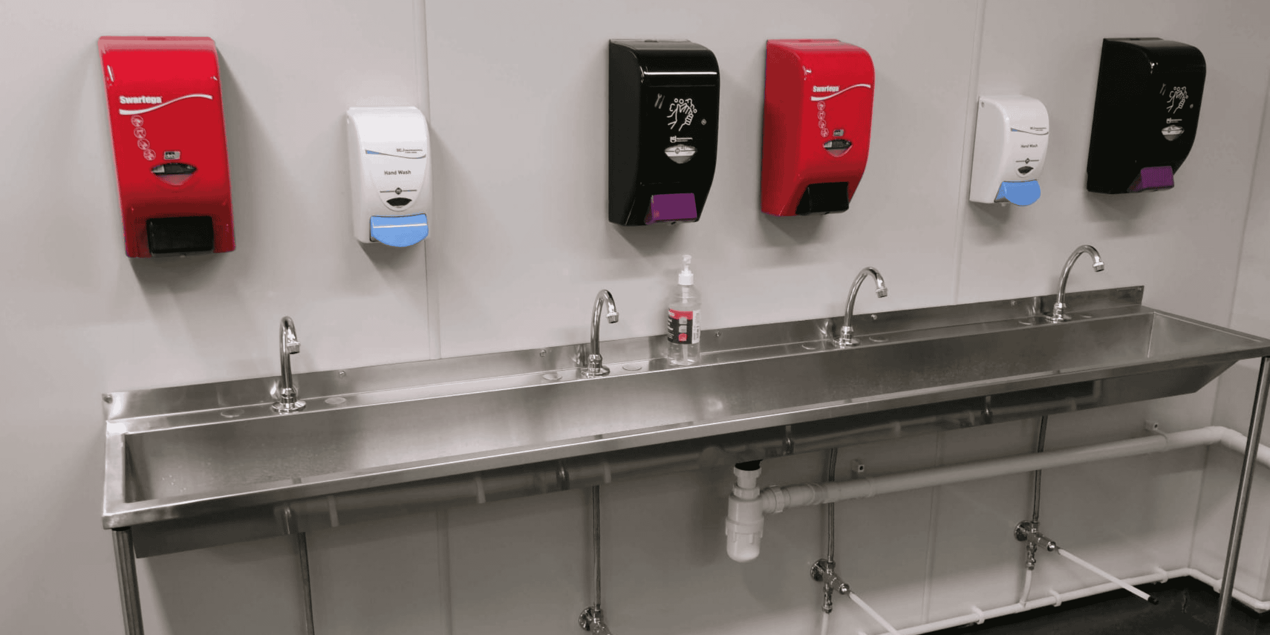 Modern stainless steel sink with soap dispenser installed on a countertop at MC Trucks site