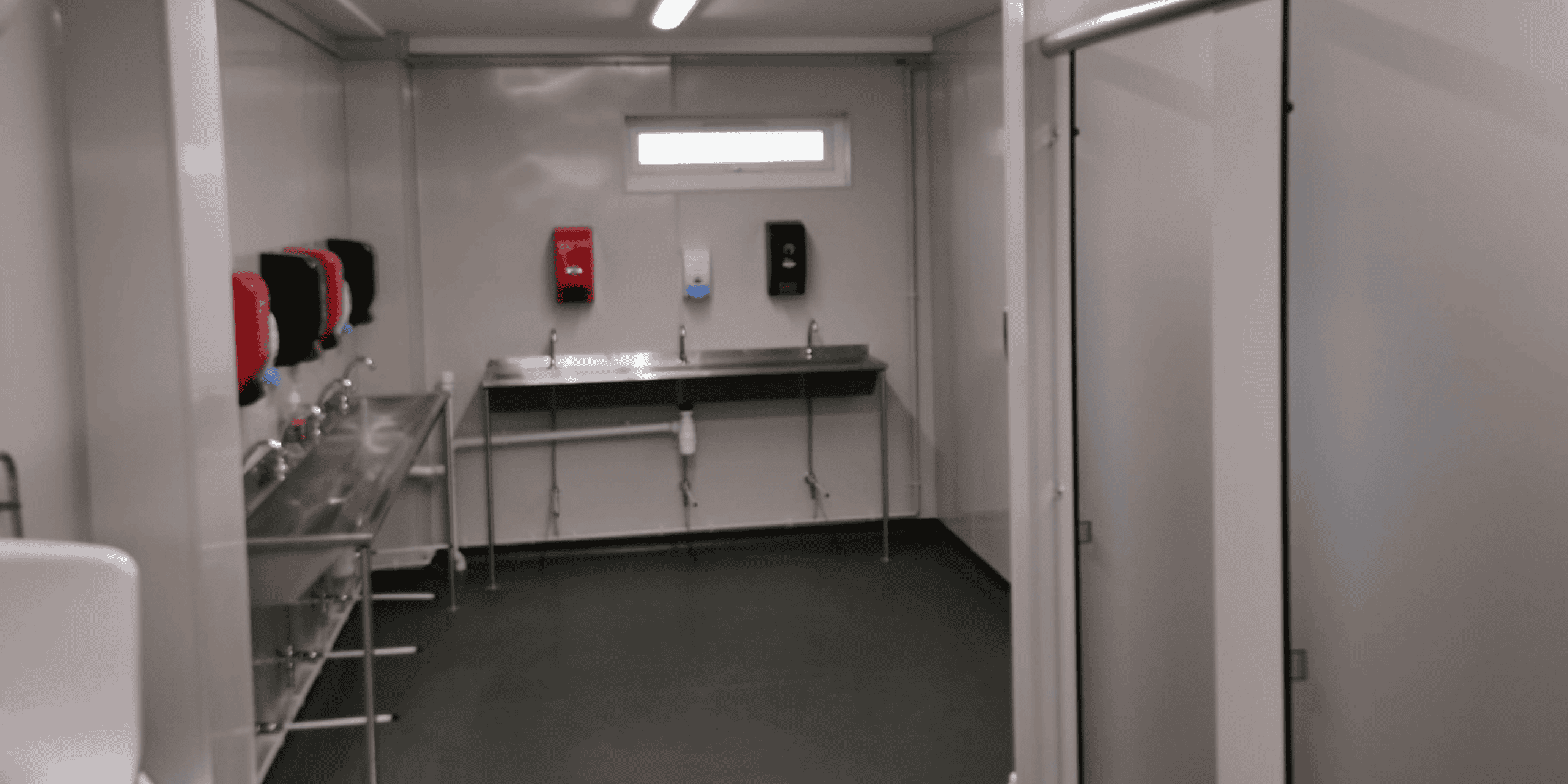 Interior walkway of modular office at MC Trucks site with windows and doors