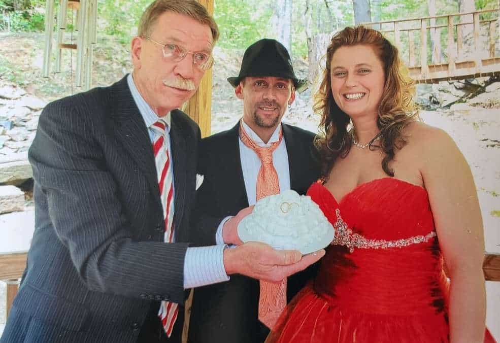 Elegant couple celebrating at Smoky Fans Social in scenic outdoor setting, showcasing community and friendship.