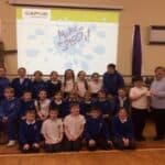 group of pupils staning in front of a make a splash presentation screen