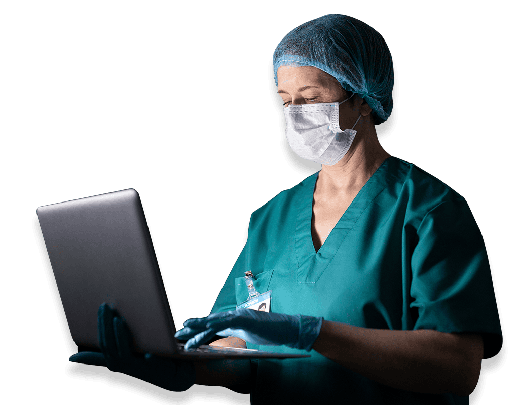 Medical professional working on a laptop in a clinical setting.