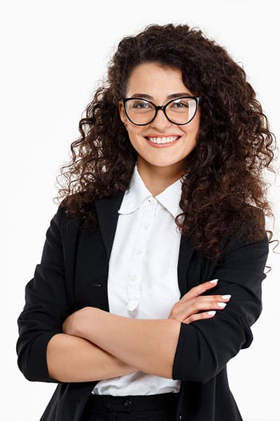 Friendly businesswoman with curly hair and glasses smiling confidently, representing professional services in Australia.
