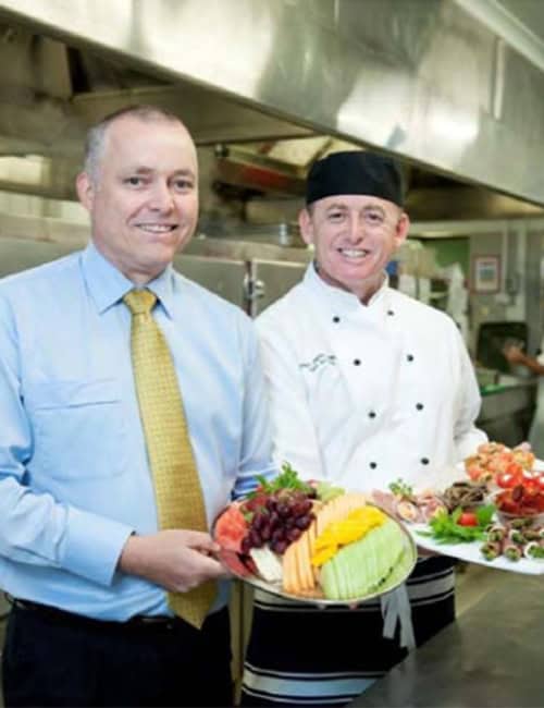 Fresh fruit platter served by staff in a commercial kitchen at Softlogic Australia.