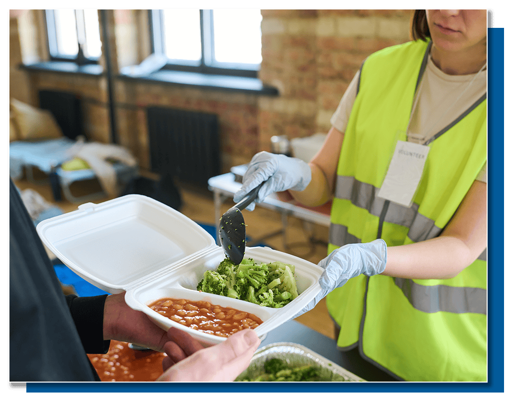 Food delivery service worker distributing meal in eco-friendly container.