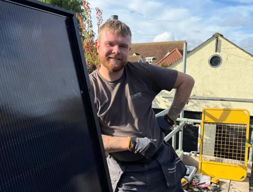 A friendly solar panel technician from Solarose installing high-efficiency solar panels on a residential rooftop, showcasing our commitment to sustainable energy solutions.