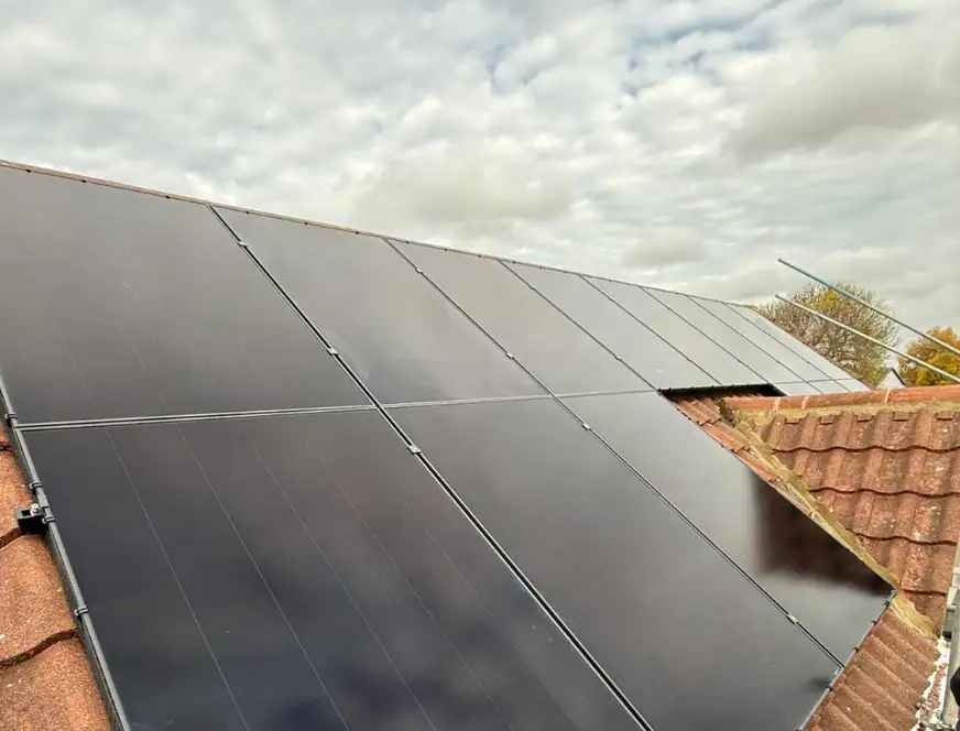 Solar Panel Installers maidstone, Black solar panels installed on a rooftop, capturing sunlight to generate renewable energy, ideal for Maidstone homes seeking eco-friendly energy solutions.