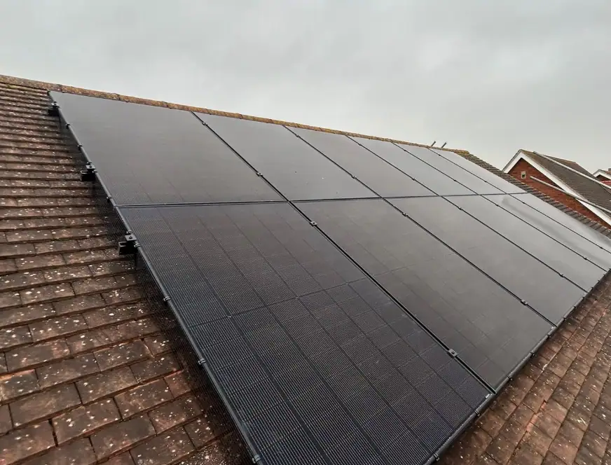Solar energy system on residential roof with black solar panels.