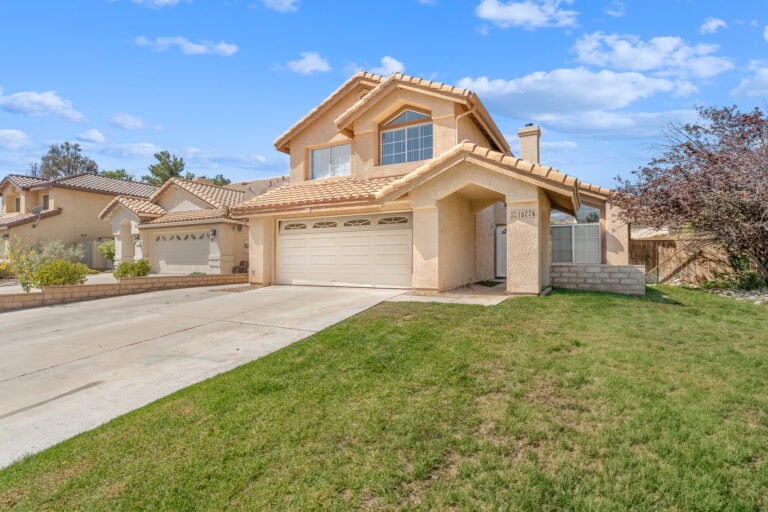 Spacious two-story house in Yucaipa, CA with a well-maintained lawn, attached garage, and modern design, perfect for families seeking a comfortable home.