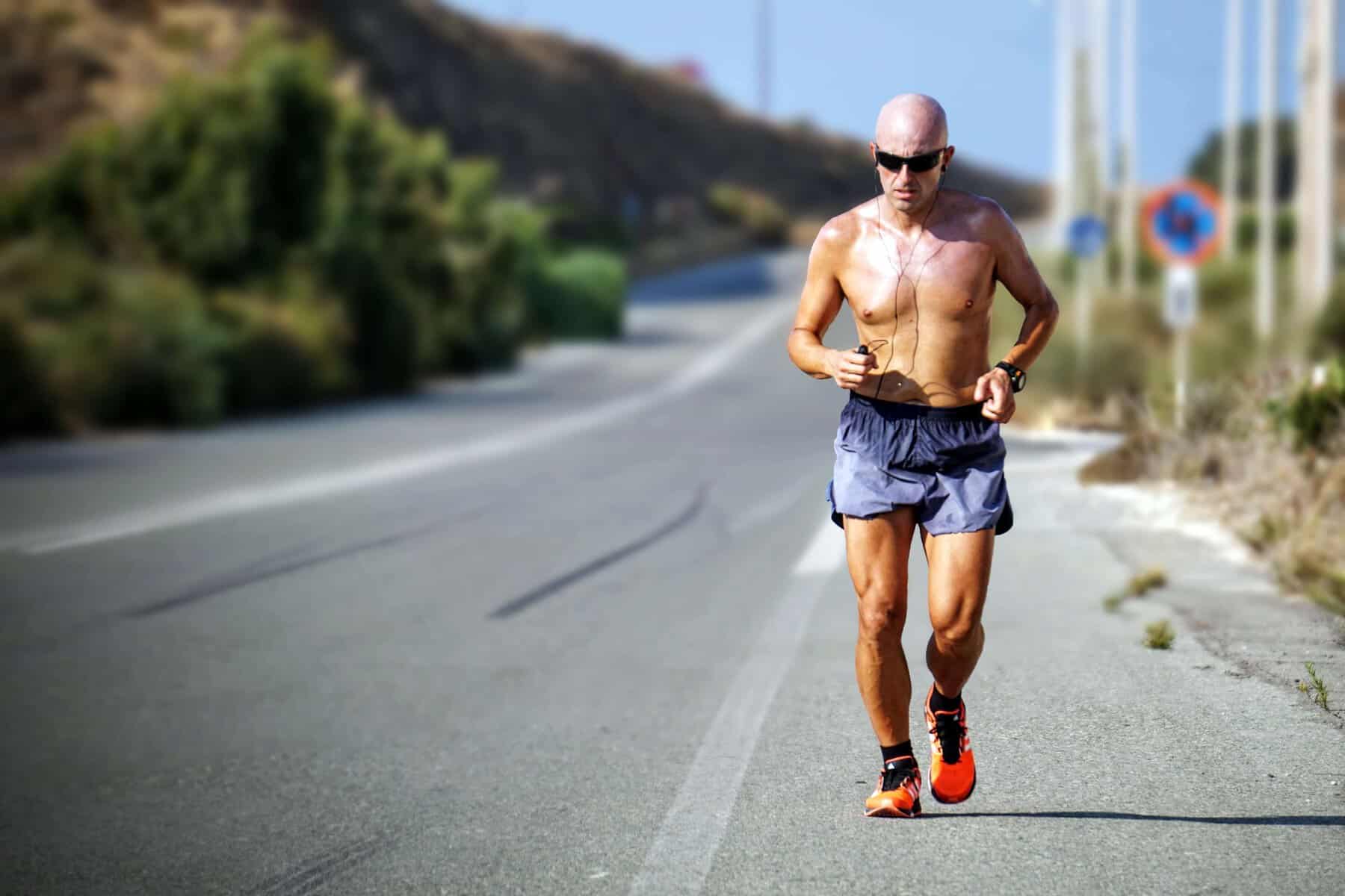 Balanced runner running on a scenic coastal road, fitness, endurance, outdoor exercise, marathon training, summer outdoor activity, athletic workout, cardiovascular health, Rock City Running.