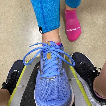 Comfortable blue running shoe on a treadmill at Rock City Running, perfect for fitness enthusiasts and runners.