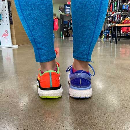 Colorful running shoes for women on display at Rock City Running store, perfect for trail and road running enthusiasts.