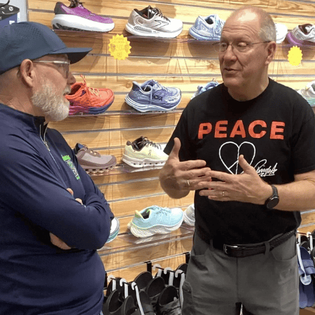 Comfortable running shoes display at Rock City Running store with staff advising customers on athletic footwear options.