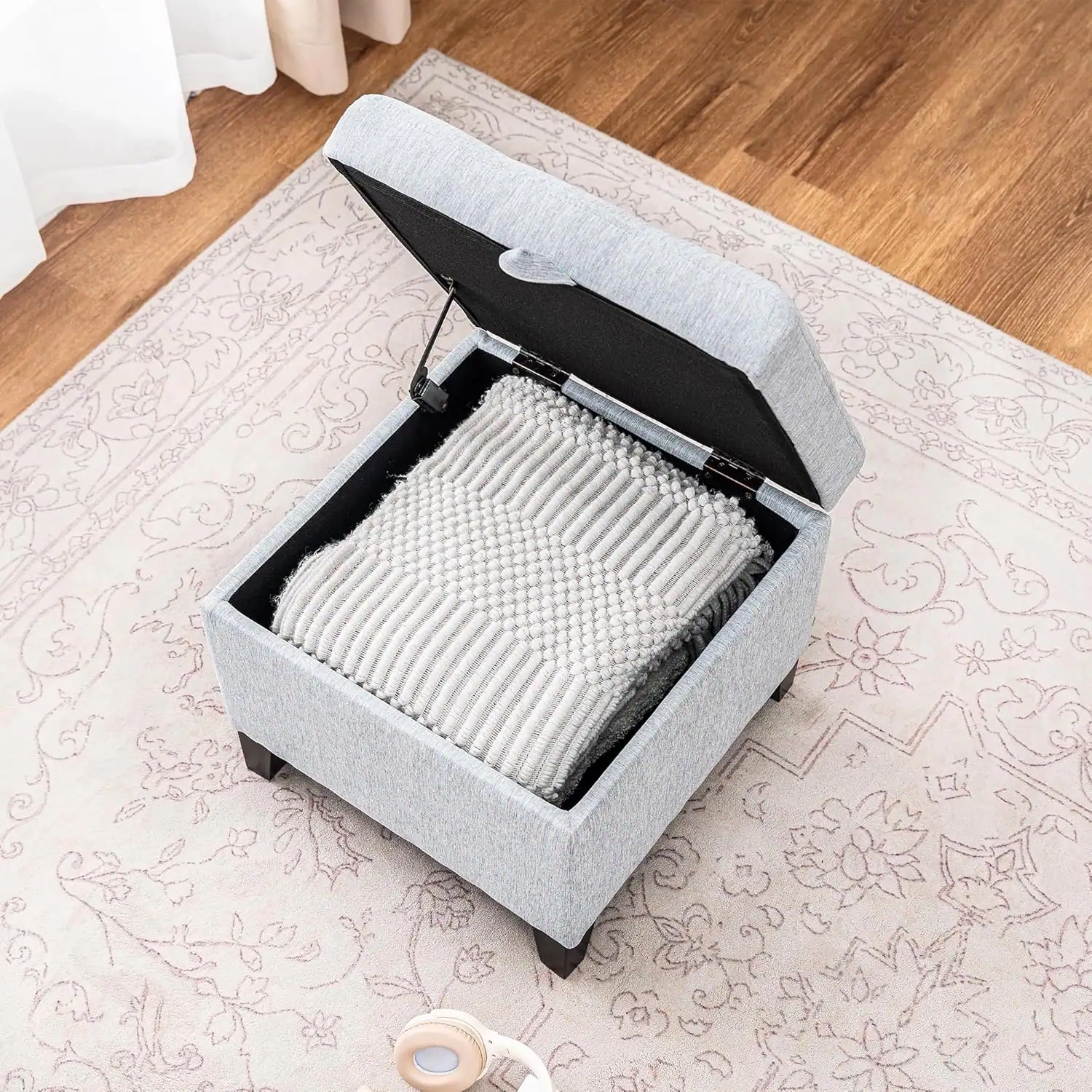 Efficient storage ottoman with organized fabric bins, ideal for small dorm room spaces.