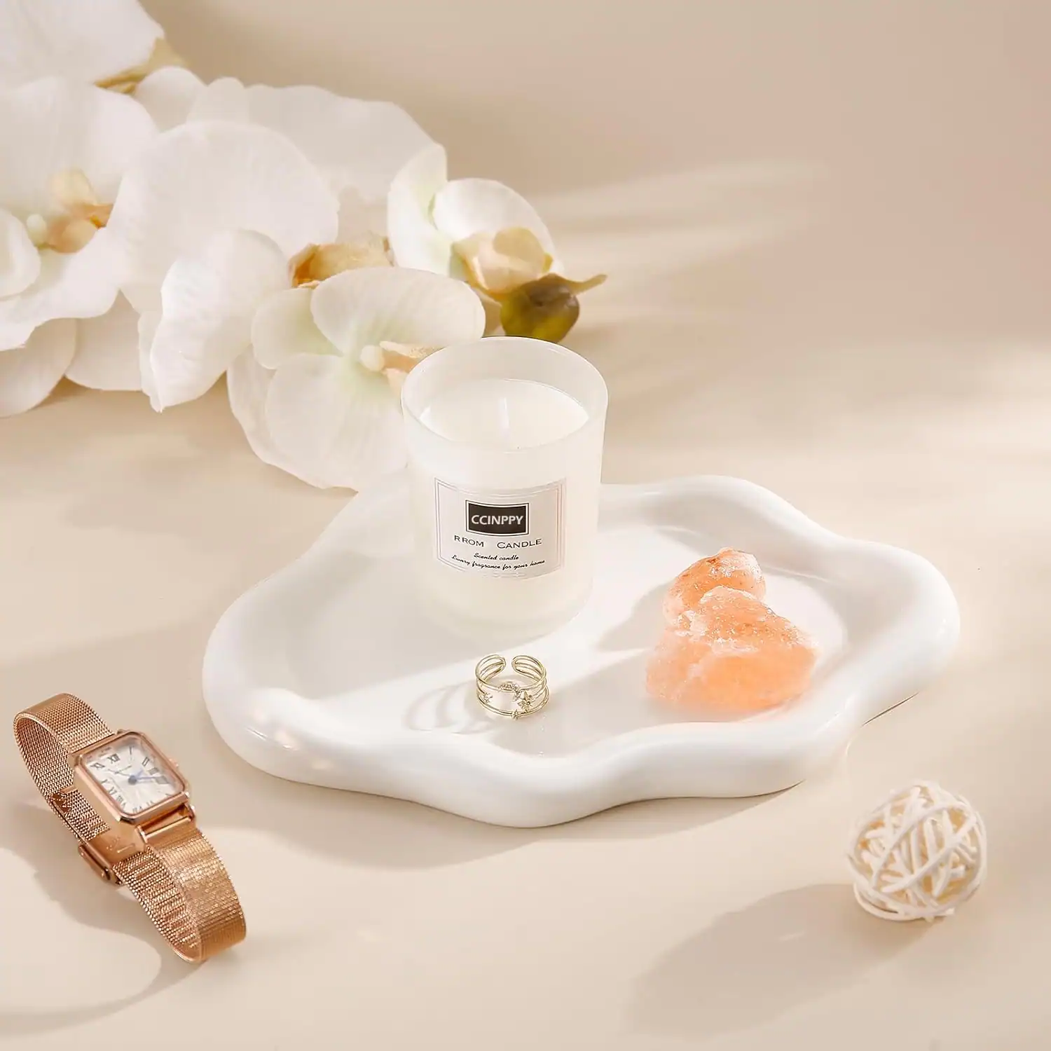 Minimalist home decor with candles, rings, and decorative accents.