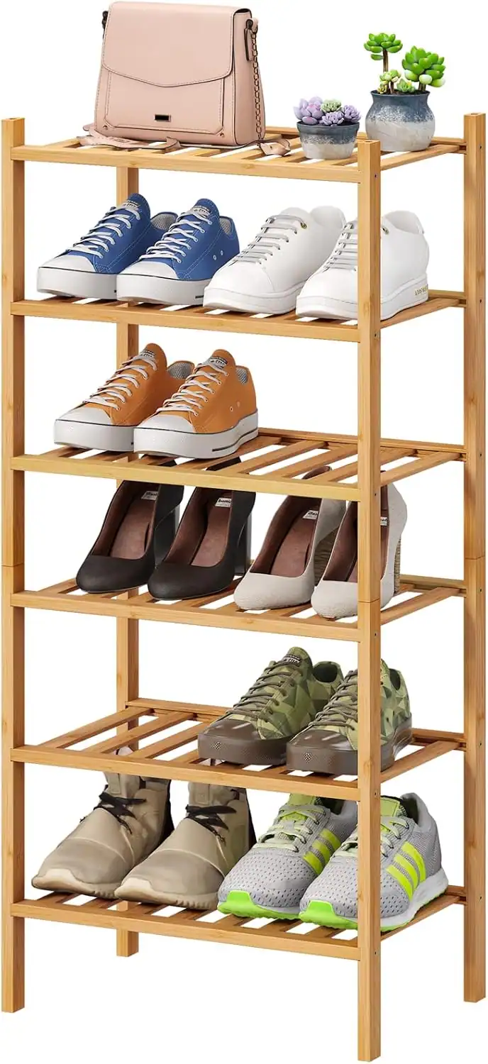 Entryway shoe storage with shelves and decorative plants.