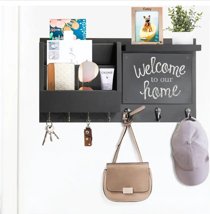 Entryway organization with hooks, bags, and decor in a small apartment.
