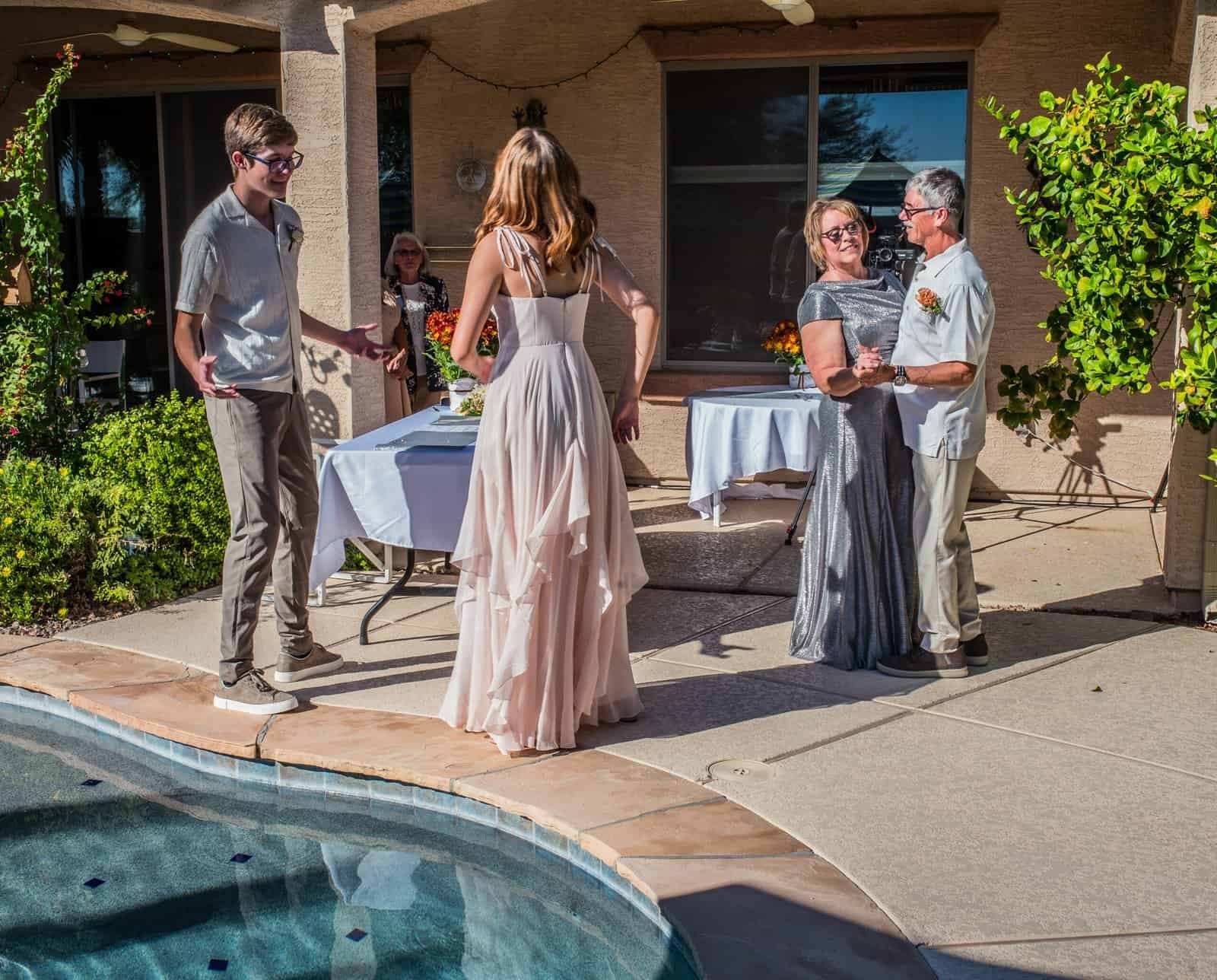 A heartfelt moment during a wedding celebration outdoors.