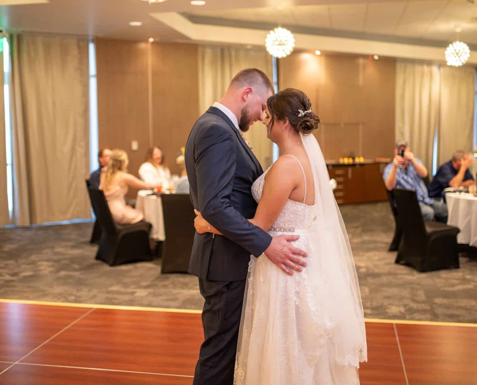 Romantic first dance of a bride and groom during their wedding reception captured beautifully.