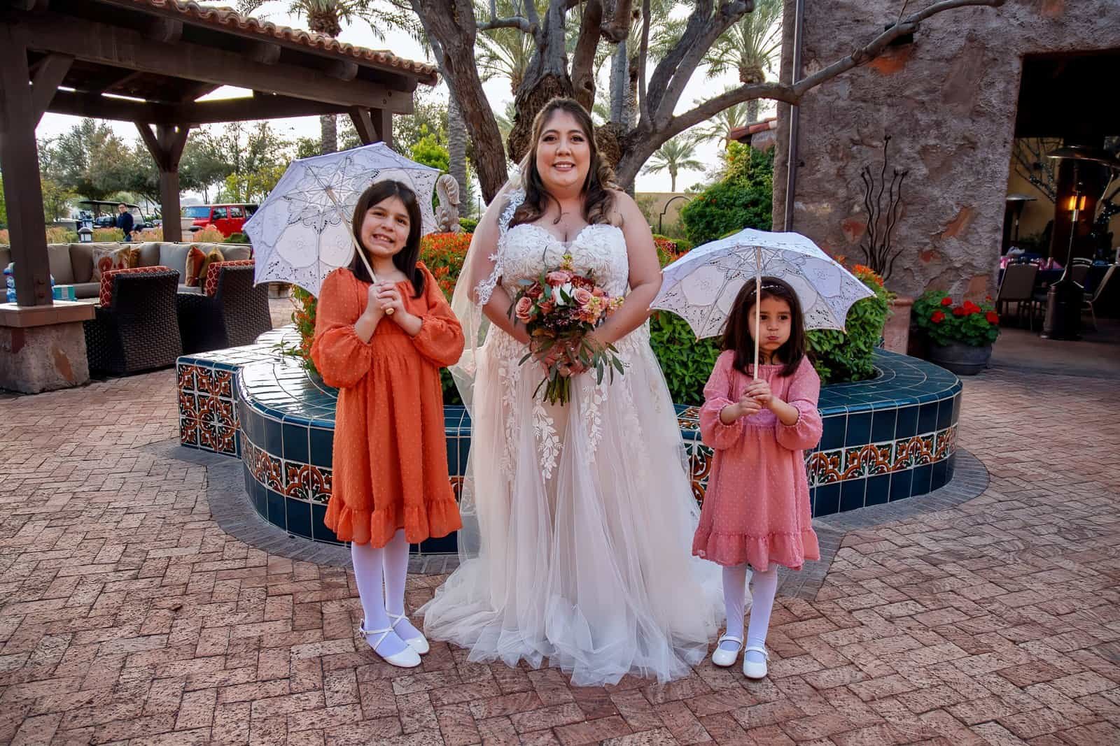 Joyful wedding moment with children and bride outdoors, capturing happiness and celebration.