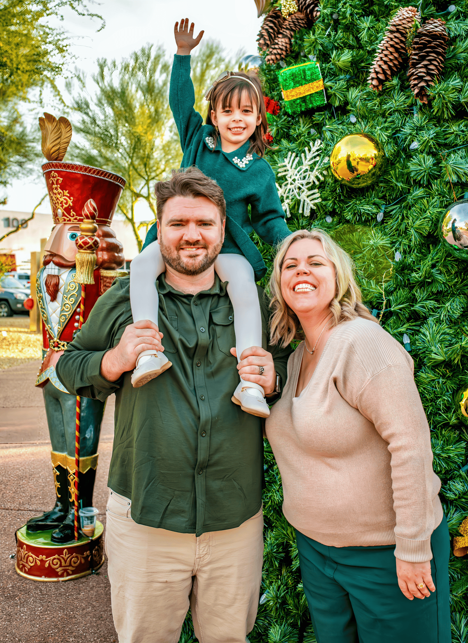 Joyful family enjoying holiday season with Christmas tree and ornaments.