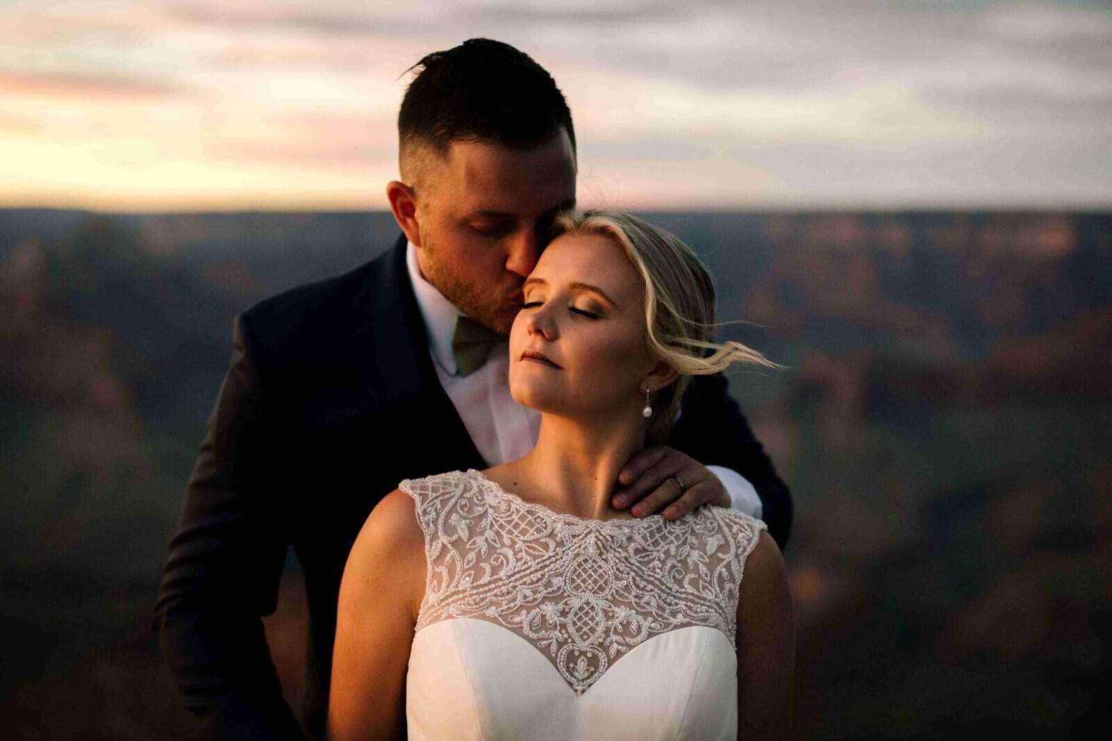 Beautiful wedding scene capturing a couple's intimate moment at sunset, emphasizing love and celebration.