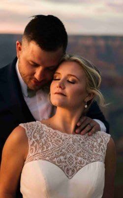 Beautiful bride and groom sharing an intimate moment during their wedding at sunset, capturing love and happiness.