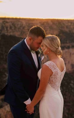 Beautiful bride and groom sharing a romantic moment during sunset.