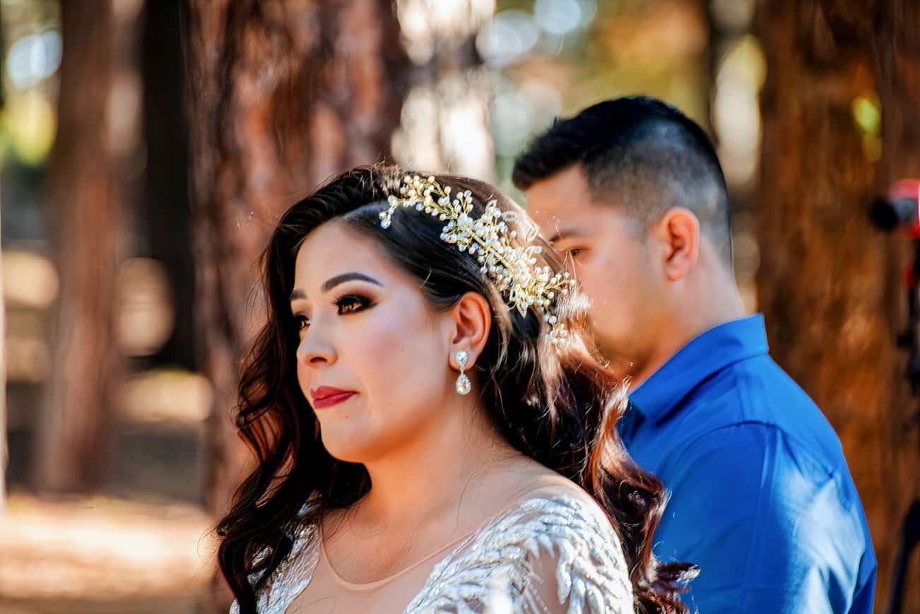 A beautifully captured moment of a bride and groom in a scenic woodland, highlighting love and celebration for wedding memories.