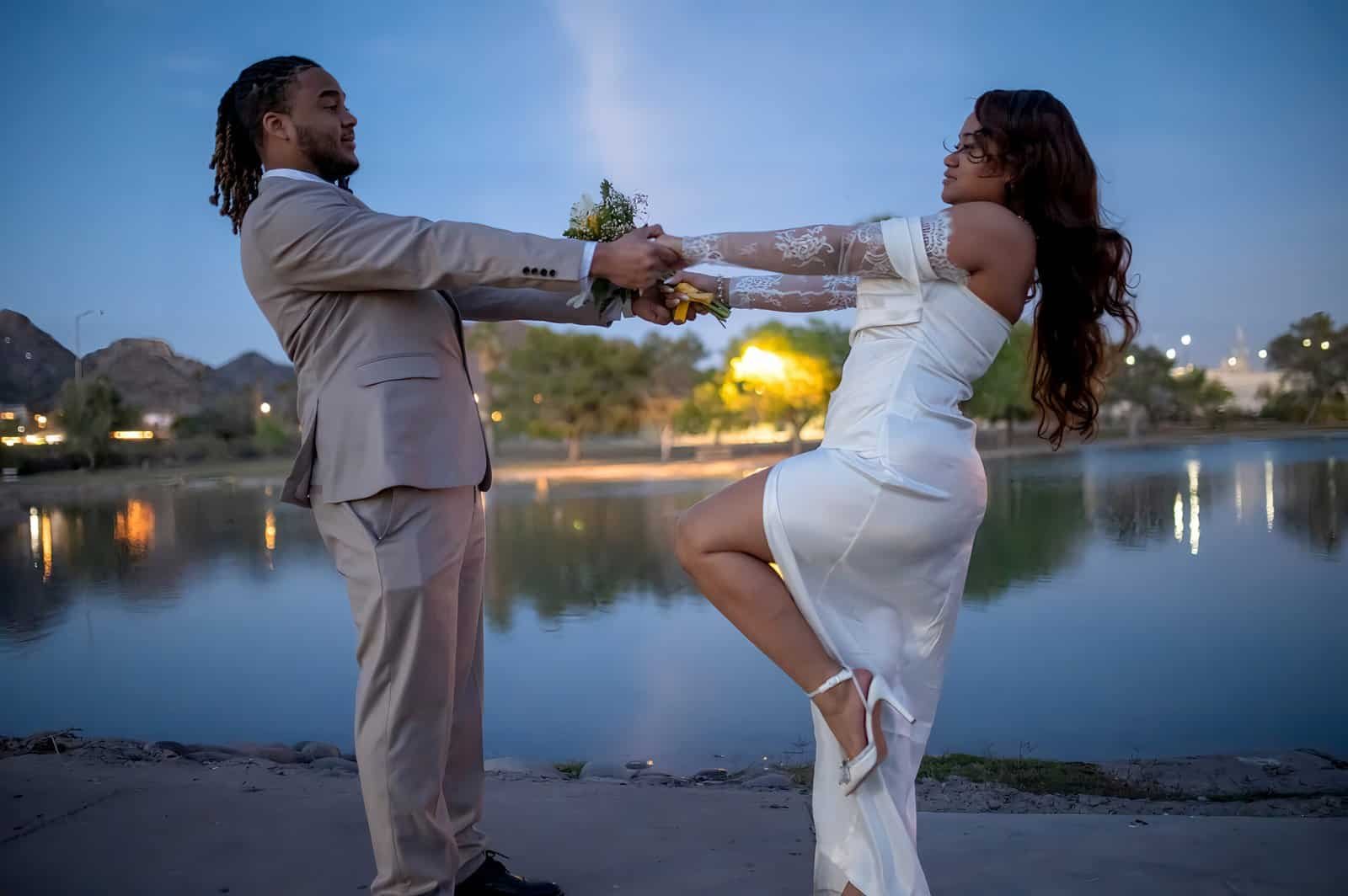 A romantic moment captured of a bride and groom by the water, symbolizing love and commitment.