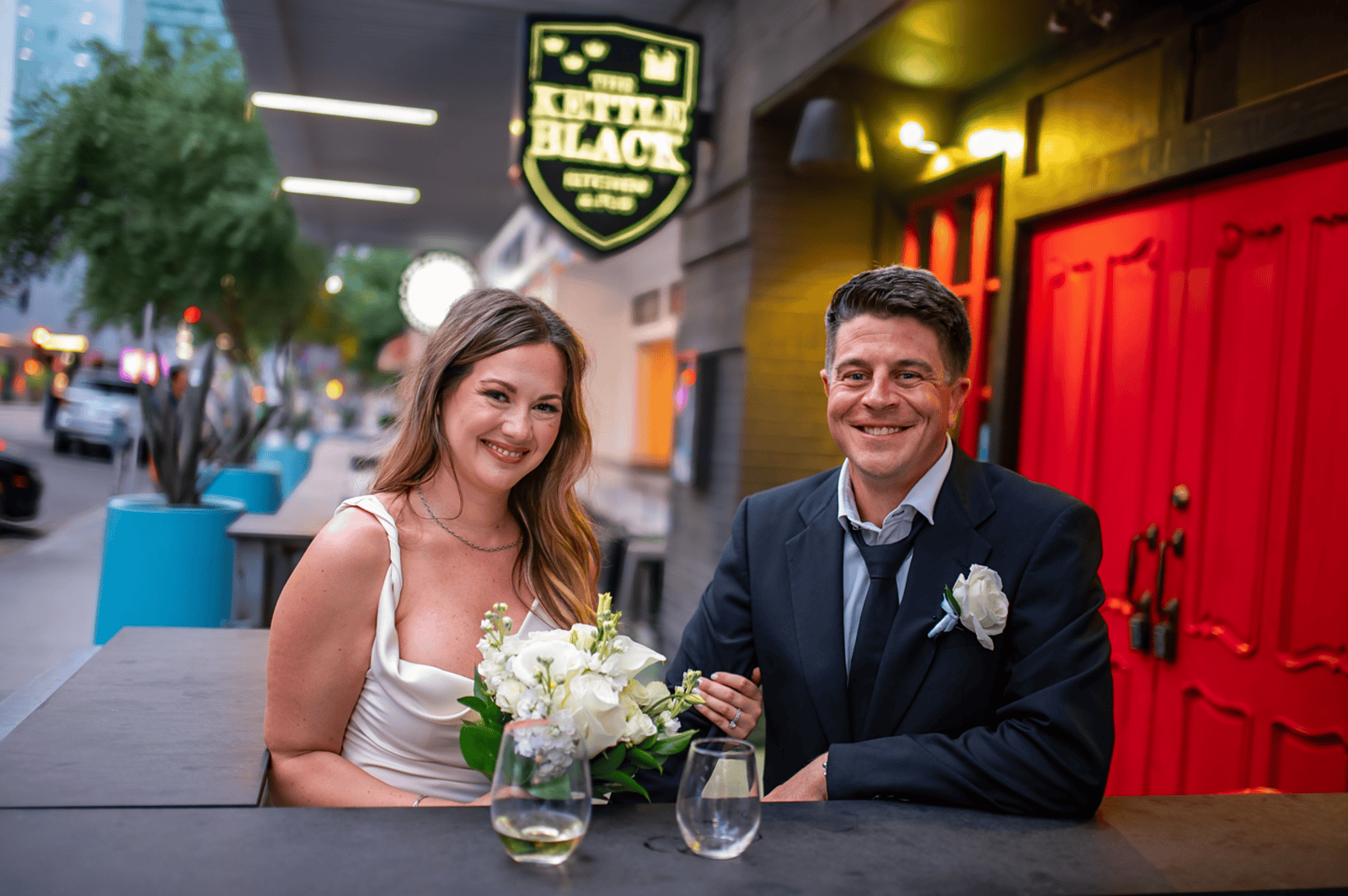 A joyful bride and groom sharing a happy moment at their wedding reception, capturing love and celebration.