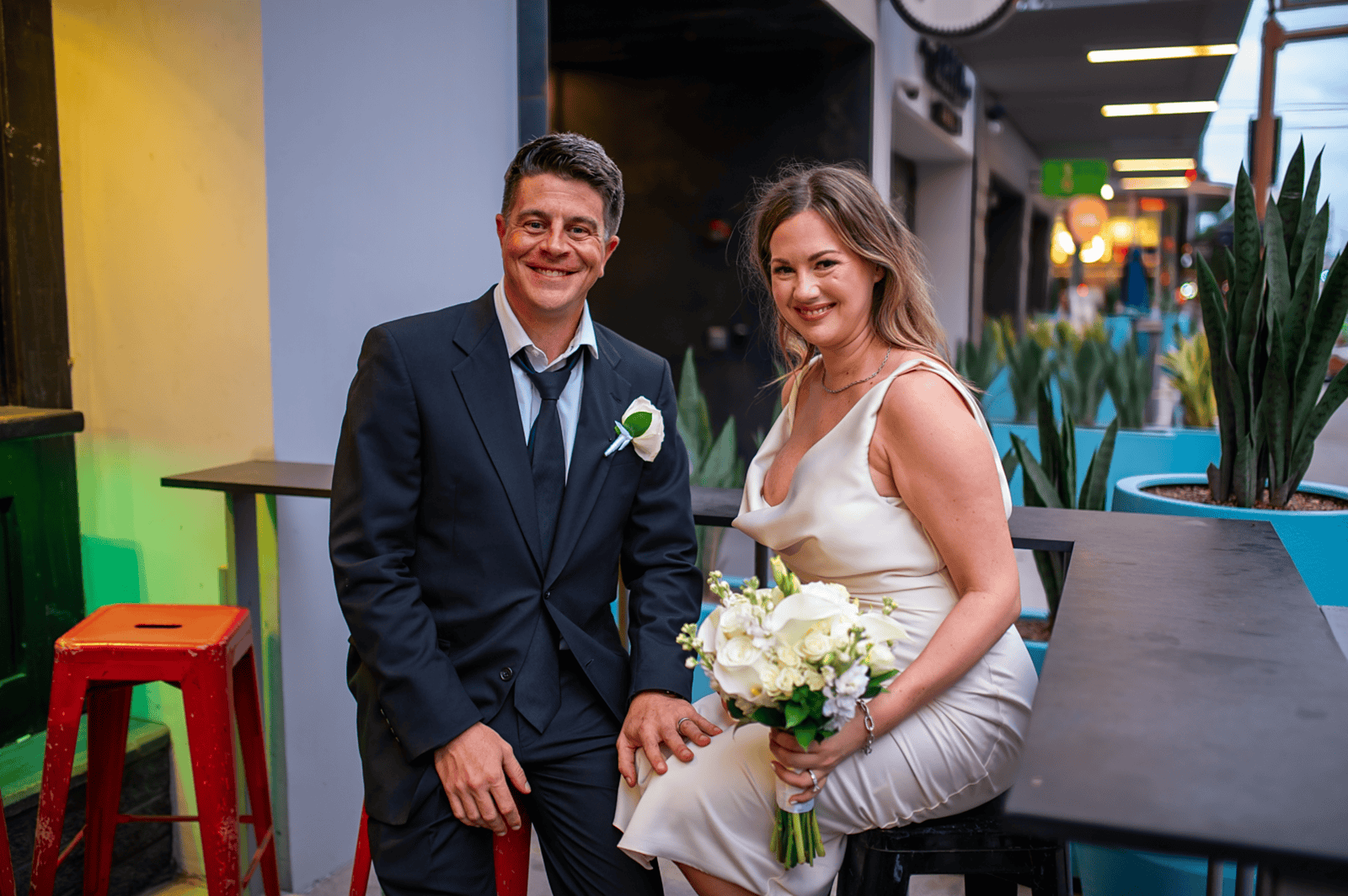 A bride and groom sharing a joyful moment at their wedding reception, showcasing love and happiness.